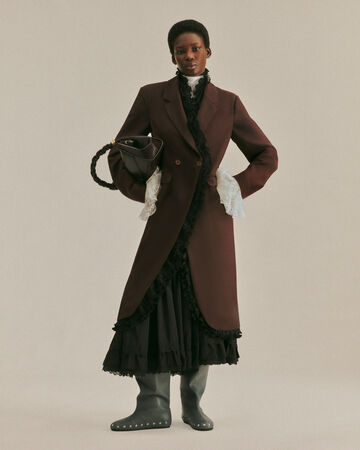 Model wearing brown coat from the Fall/Winter 2026 collection